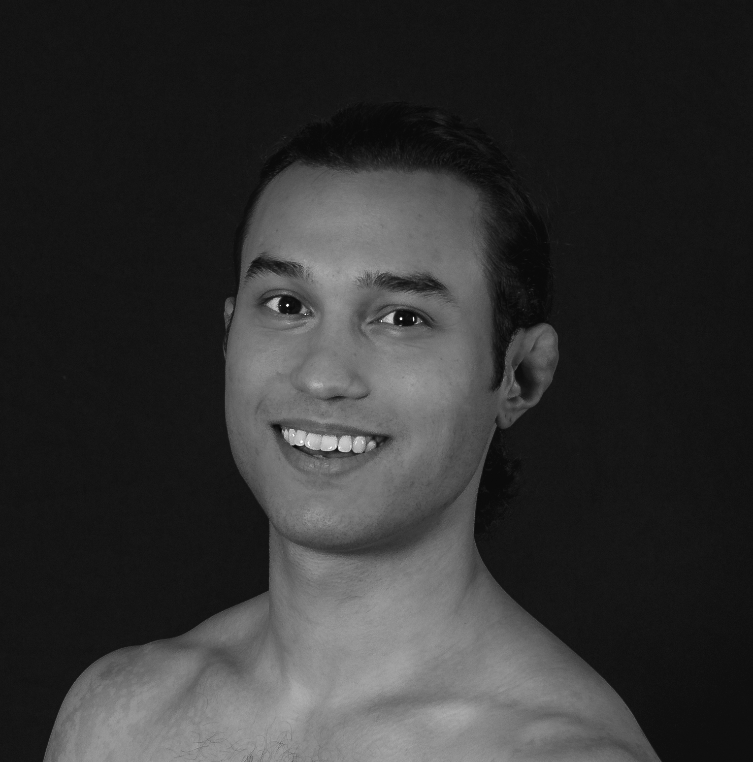 Marco Clemente - headshot of male dancer with curly, dark hair and brown eyes.