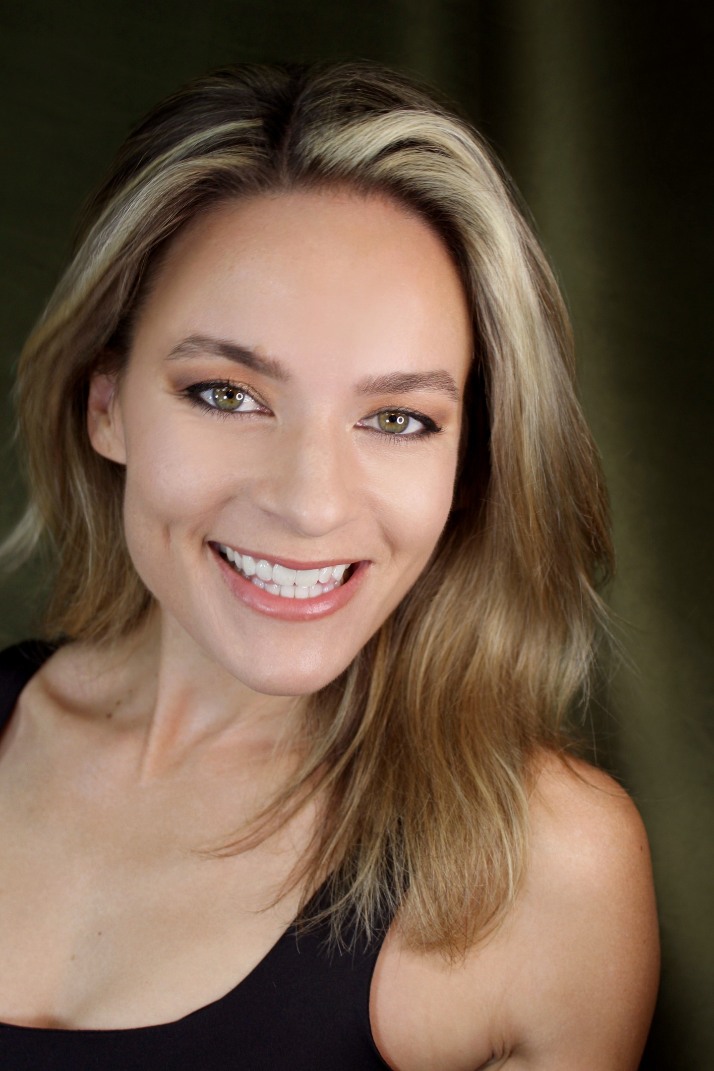 Headshot of Jessica, a white woman with blonde hair and green eyes. She is smiling at the camera.