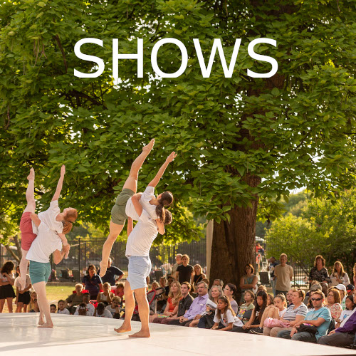 Text: Shows - 4 dancers on an outdoor stage in front of a large audience