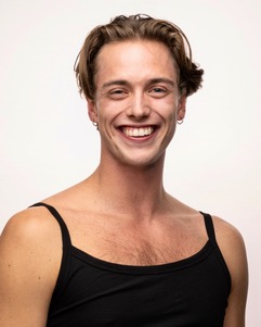 Headshot of Tyler - Male presenting dancer, 6’2 with brown hair and blue eyes