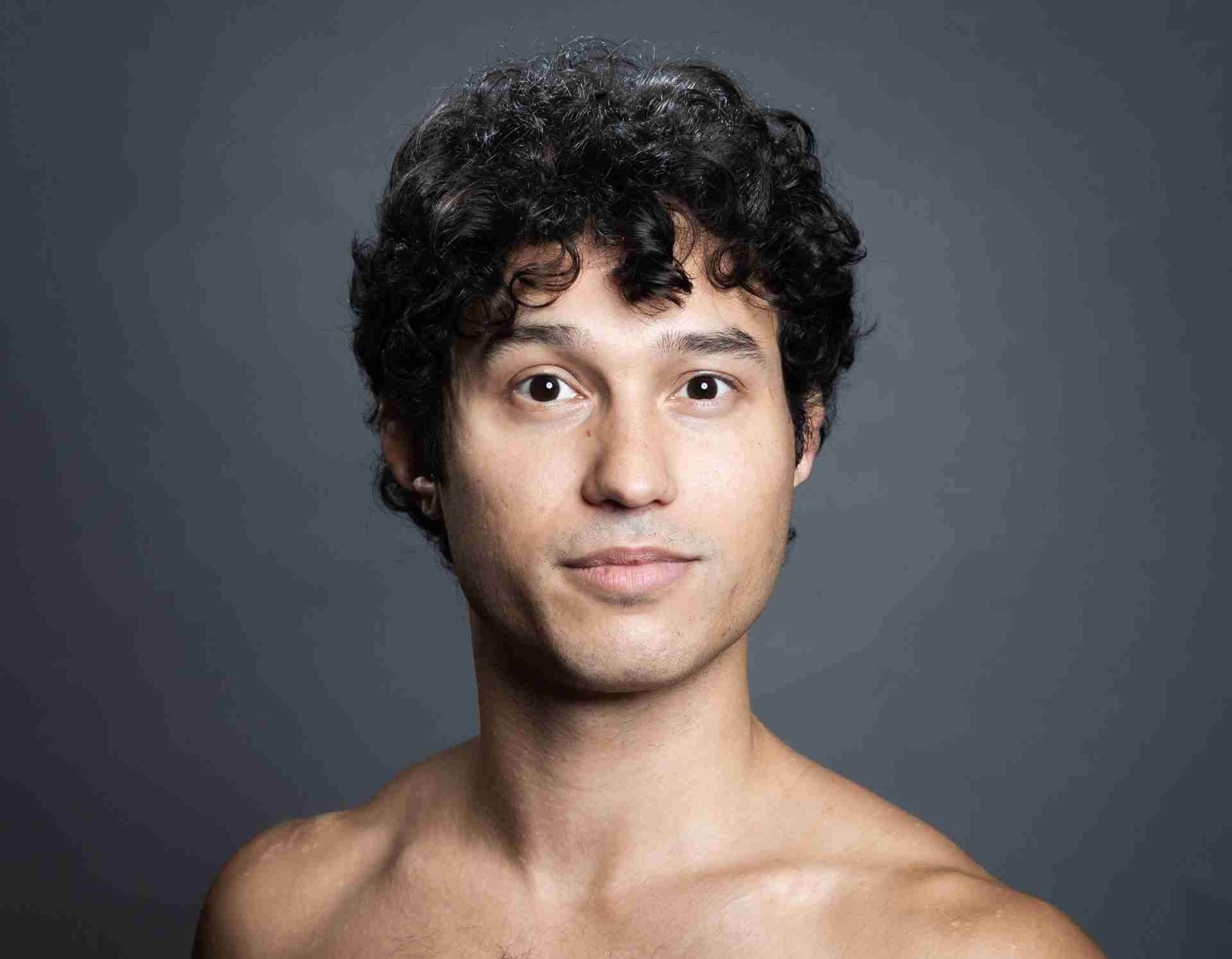 Headshot of Tyler - Male presenting dancer, 6’2 with brown hair and blue eyes